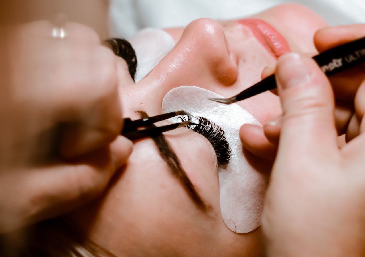 A lash artist applying eyelash extensions